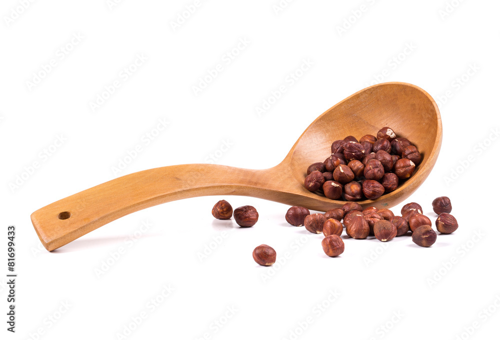 Fototapeta premium Wooden spoon with nuts
