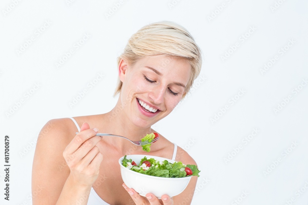 Beautiful blonde woman eating salad