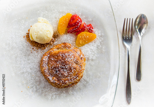 Apple pie in puff pastry served with ice cream and candied fruit