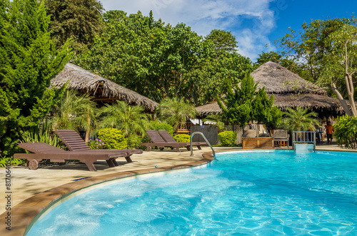Beautiful luxury swimming pool next to an exotic beach