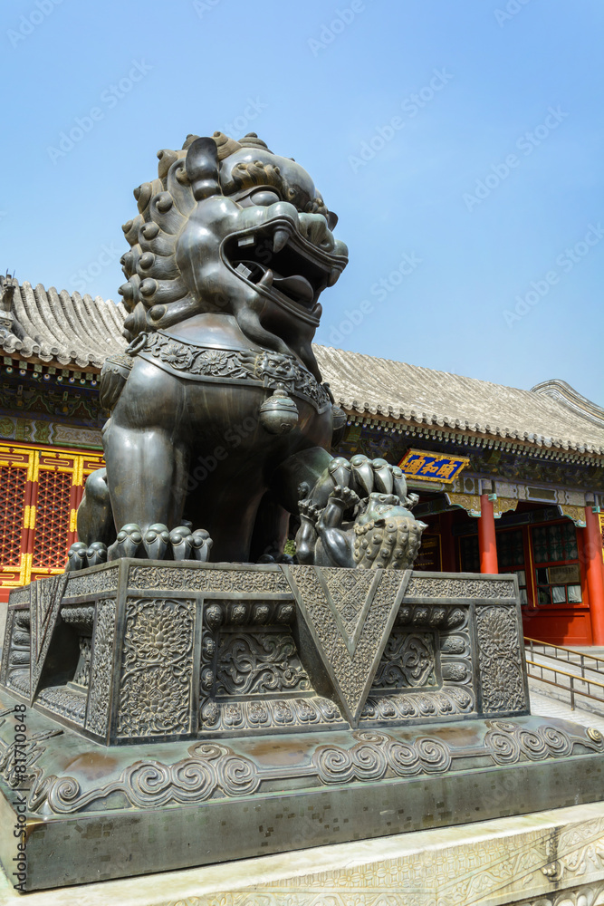 Copper lion in front of an ancient architecture in summer palace Copper lion in front of an ancient architecture in summer palace