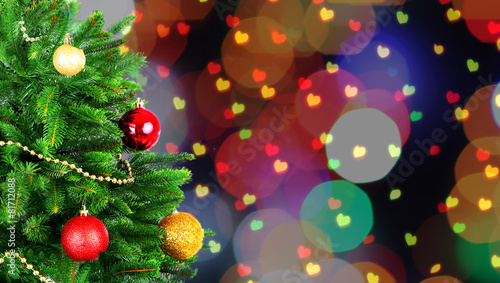 Decorated Christmas tree on festive shiny background