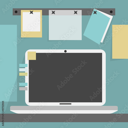 Open laptop on the desk on cubicle background wall