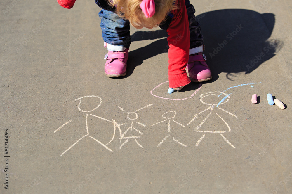 Naklejka premium little girl drawing with chalk on asphalt