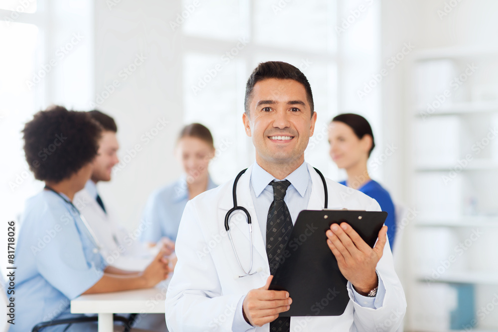 happy doctor with clipboard over medical team