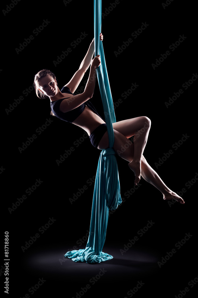 Fototapeta Young woman gymnast with blue gymnastic ribbon