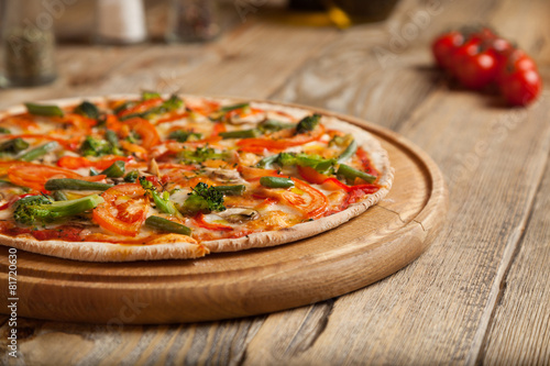 Italian pizza "Vegetarian" on a wooden table.