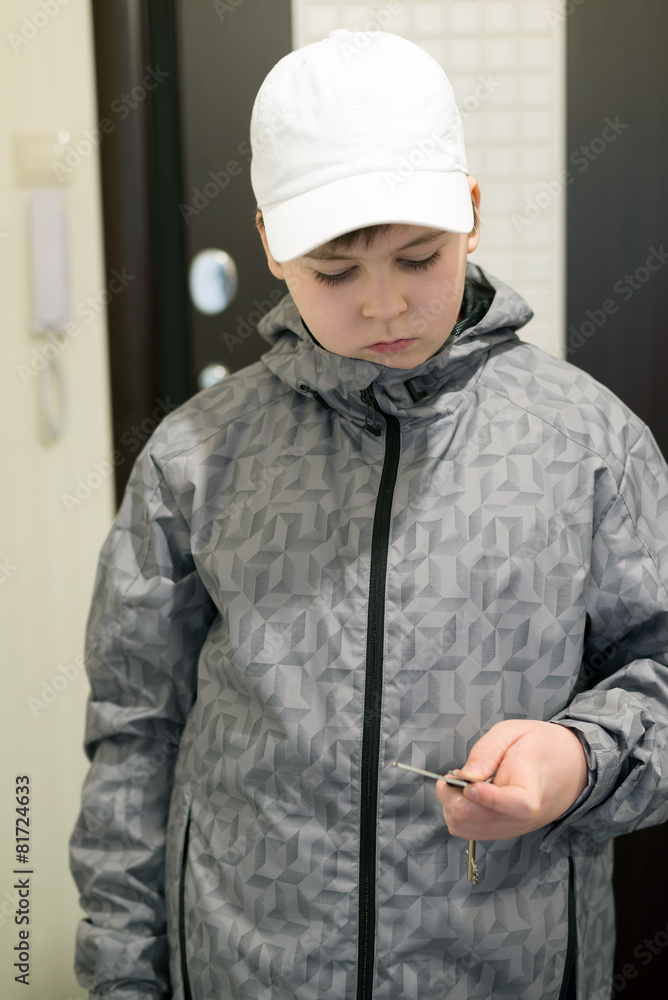 boy standing at front door of the house boy standing at front door of the house