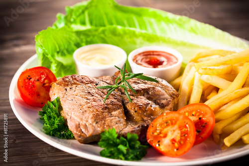Grilled steaks and vegetable salad