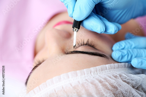 Cosmetologist applying perm...