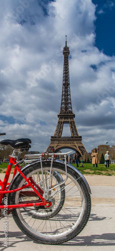red bike over Eiffel tower on background in Paris France © vladsogodel