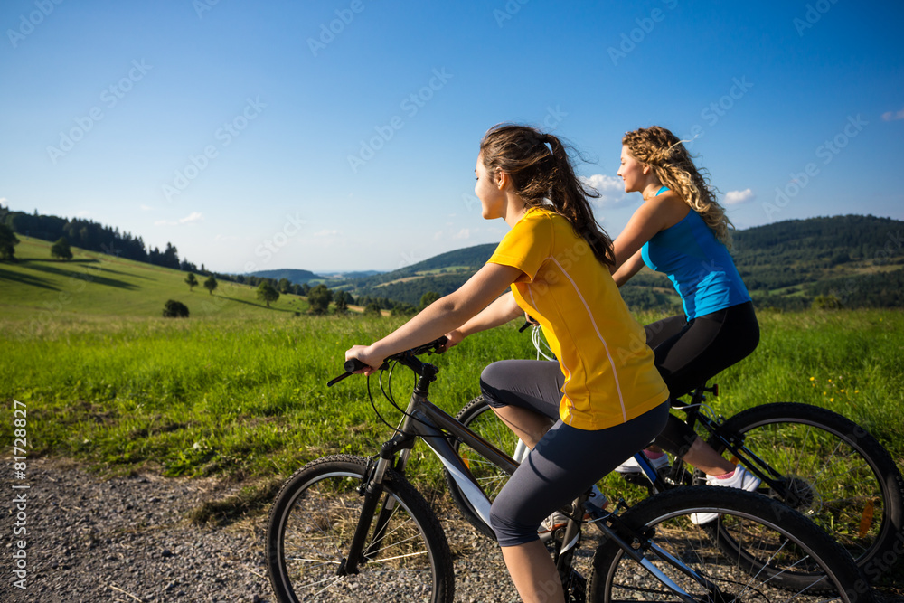 Healthy lifestyle - young women biking Healthy lifestyle - young women biking