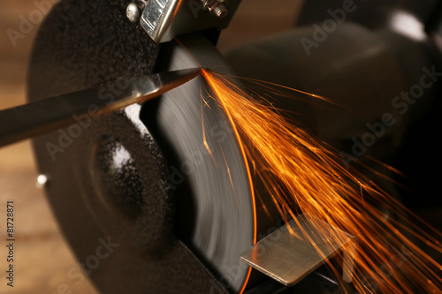 Knife sharpener on wooden table, closeup