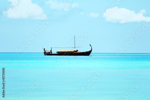 View of beautiful blue ocean water with boat in Baros Maldives © Africa Studio