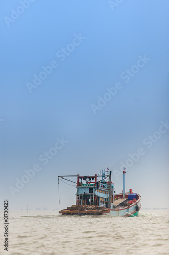 Old fishing boat floating in the sea
