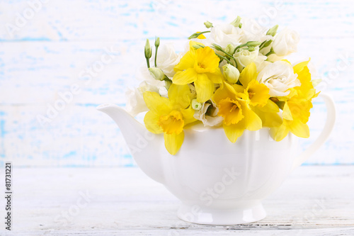 Fototapeta Naklejka Na Ścianę i Meble -  Beautiful bouquet of yellow daffodils and roses in teapot