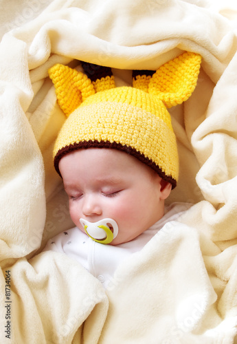 Baby sleeping in giraffe hat