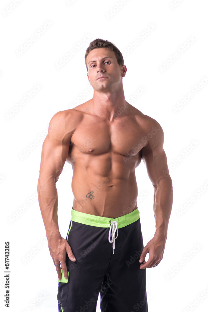 Muscular young bodybuilder in relaxed pose. Isolated Muscular young bodybuilder in relaxed pose. Isolated