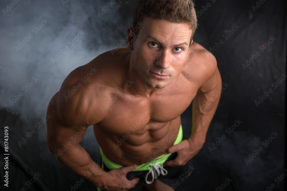 Fototapeta premium Handsome shirtless bodybuilder shot from above, standing