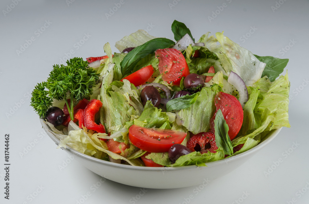 Bowl of salad with fresh vegetables on white backgroound Bowl of salad with fresh vegetables on white backgroound