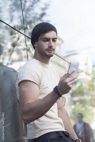 Young man talking by phone.