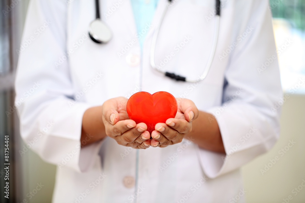 Female doctor holding a beautiful red heart shape Female doctor holding a beautiful red heart shape