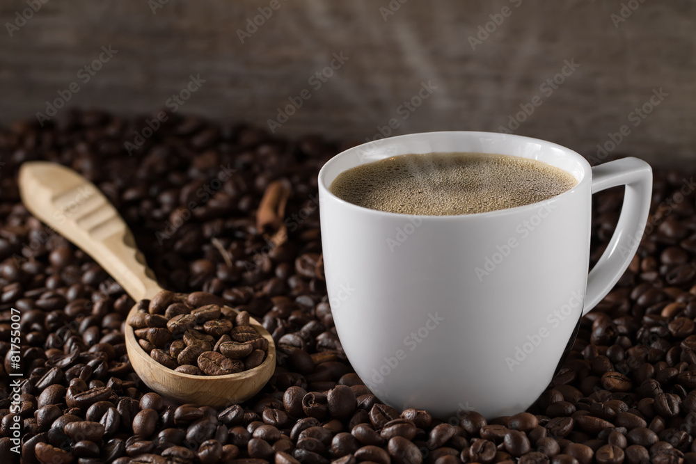 Fototapeta premium Cup French coffee with cinnamon sticks and background beans