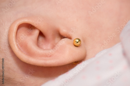 Fotografering Earring in a baby's ear