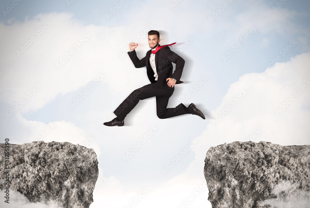 Funny business man jumping over rocks with gap Funny business man jumping over rocks with gap