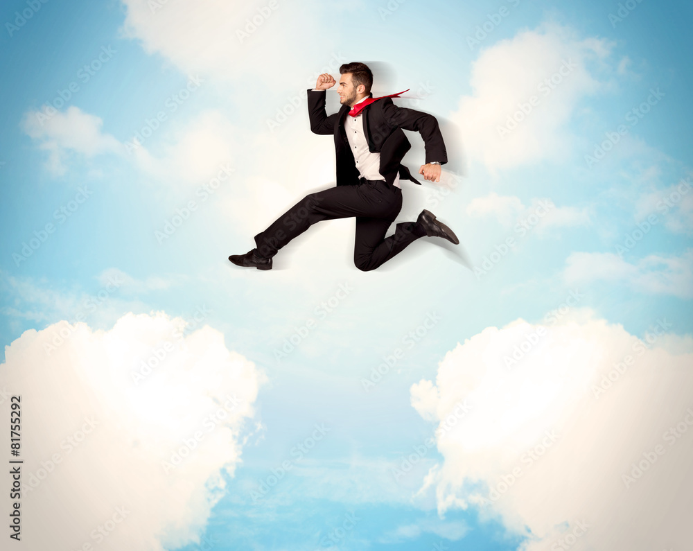 Business person jumping over clouds in the sky Business person jumping over clouds in the sky