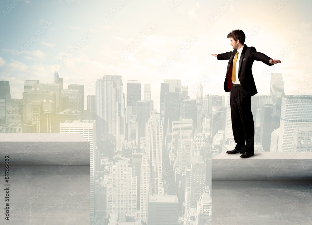 Businessman standing on the edge of rooftop Businessman standing on the edge of rooftop