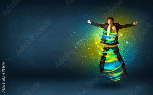 Excited business man jumping with energy colourful lines © ra2 studio