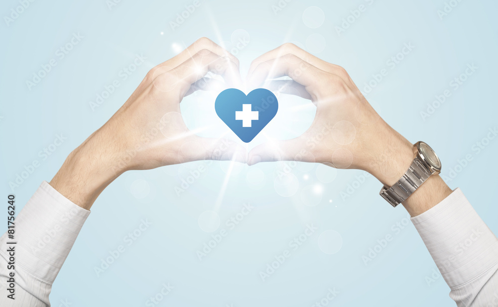 Fototapeta premium Hands creating a form with heart blue cross