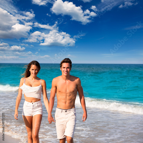 couple young walking in a tropical Mediterranean beach
