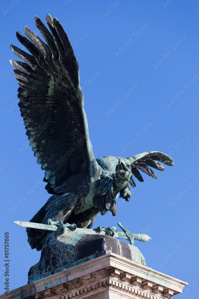 Eagle with a sword in paws against the sky