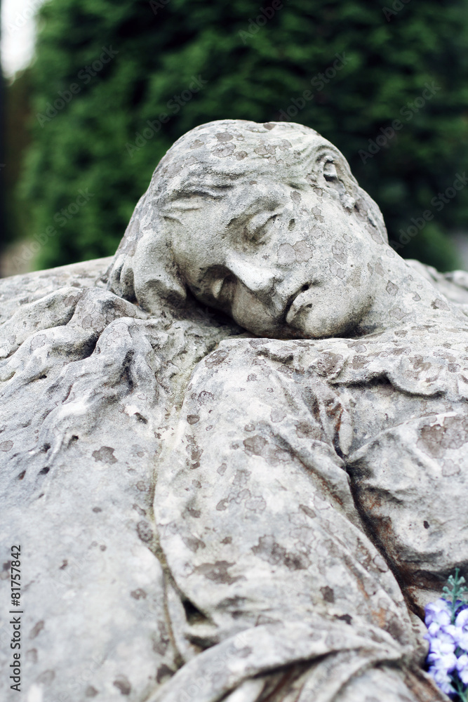 Old statue on grave in the Lychakivskyj cemetery of Lviv, Ukrain Old statue on grave in the Lychakivskyj cemetery of Lviv, Ukrain