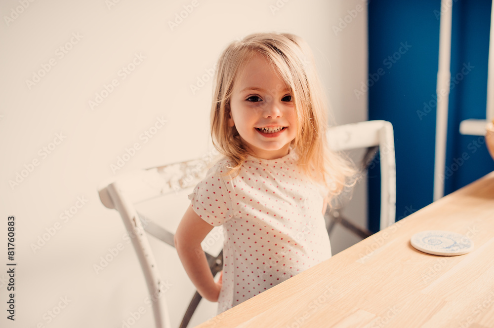 cute happy toddler girl having fun at home in kitchen cute happy toddler girl having fun at home in kitchen