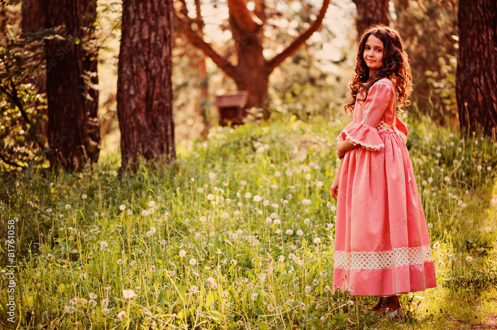 happy child girl dressed as fairytale princess in summer forest