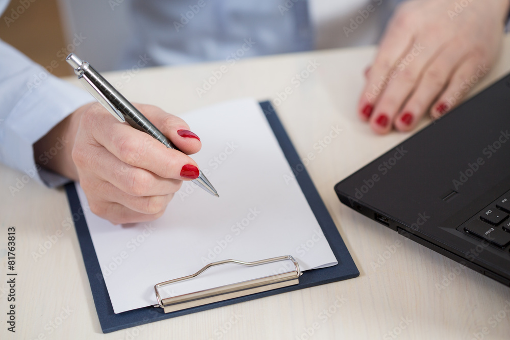 Woman writes in a notebook Woman writes in a notebook