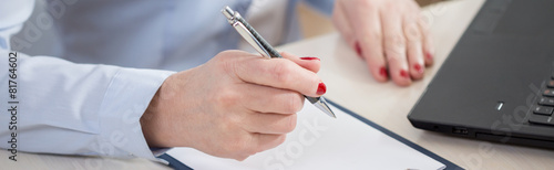 Pen in the hand of businesswoman