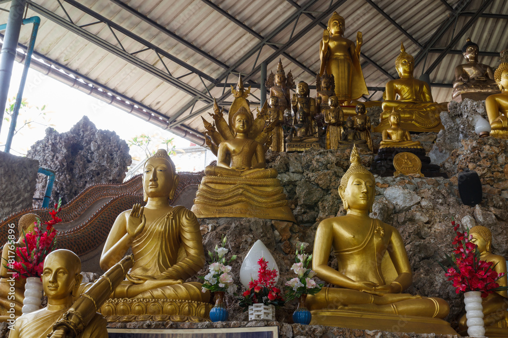 golden buddha statue on the stone