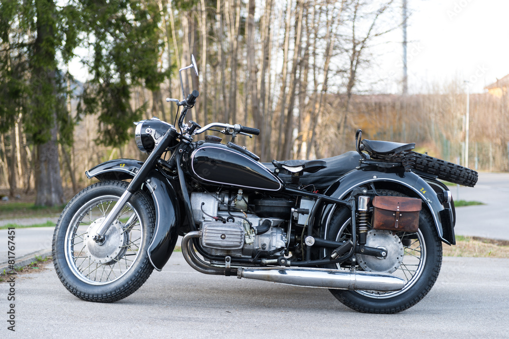 sideview of black oldtimer motorbike with sidecar an leather bag sideview of black oldtimer motorbike with sidecar an leather bag
