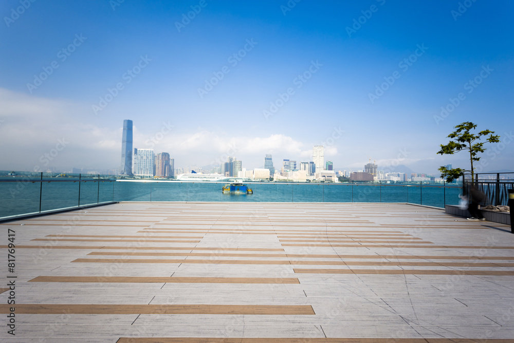 Empty footpath with cityscape at far away