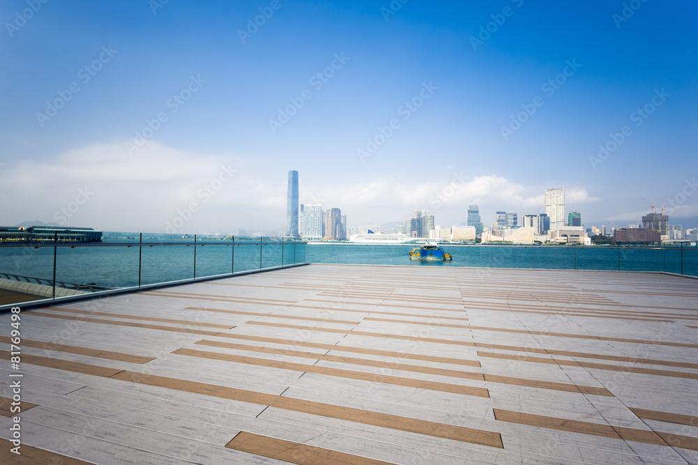 Empty footpath with cityscape at far away