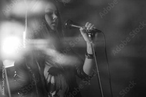 girl singing into a microphone in a studio