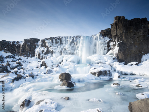Waterfall in the winter in pingvellir valley in Iceland photo