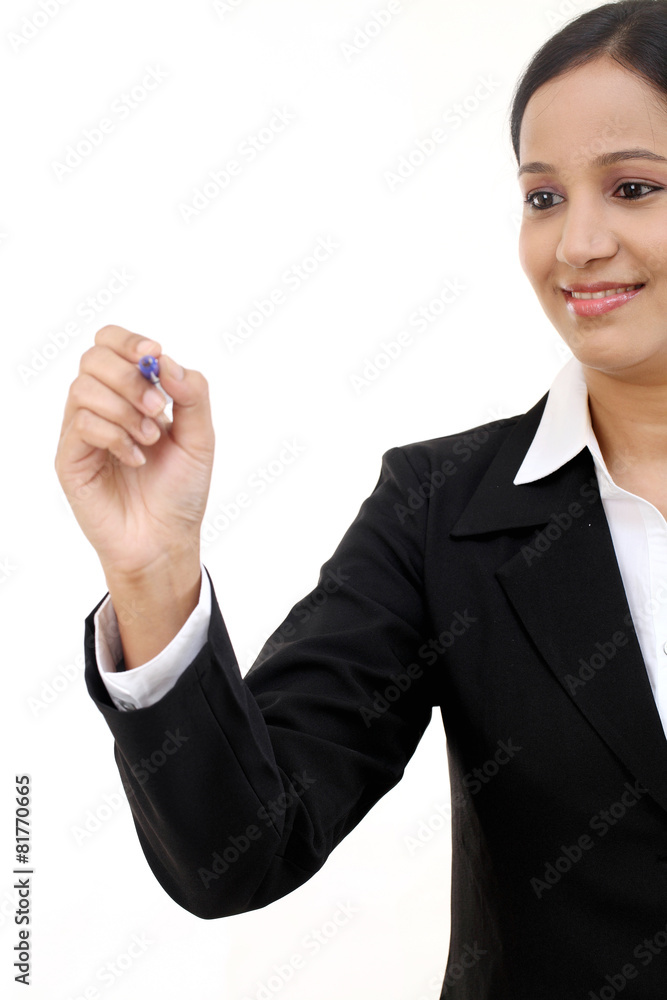Business woman writing with pen on virtual screen Business woman writing with pen on virtual screen