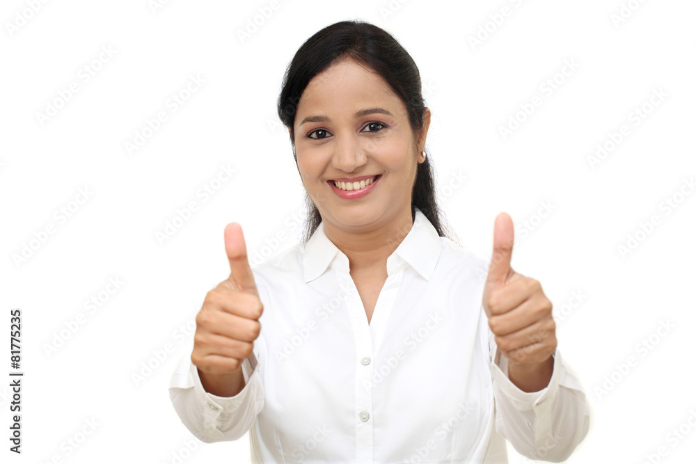 Cheerful woman with thumbs up against white background Cheerful woman with thumbs up against white background