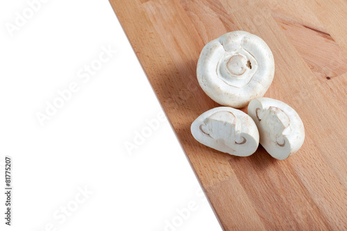 Champignons on a wooden board, white background