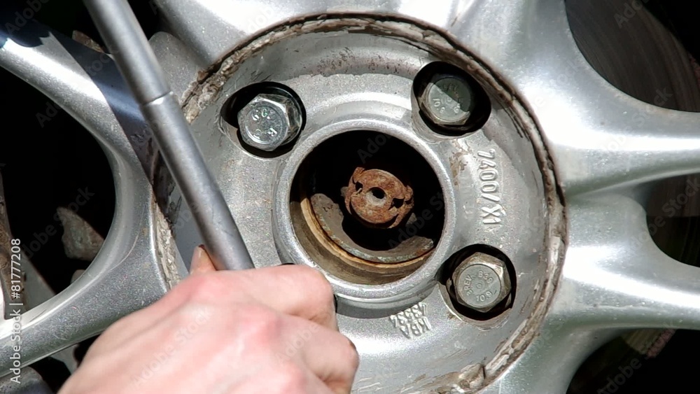 Tightening screws on the wheel a car Tightening screws on the wheel a car